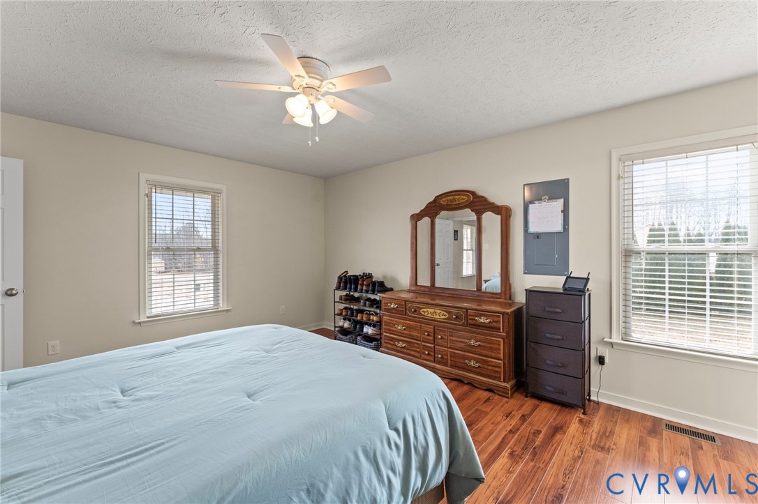 388 Berry Ridge Road Tappahannock, VA 22560 - Photo 11 of 25 a bedroom with a bed and a large window with wooden floor
