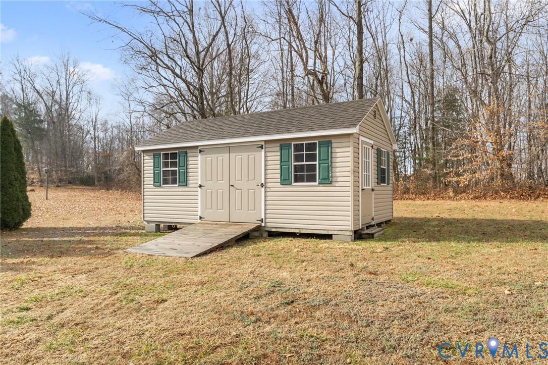 388 Berry Ridge Road Tappahannock, VA 22560 - Photo 19 of 25 a backyard of a house with large trees and wooden fence
