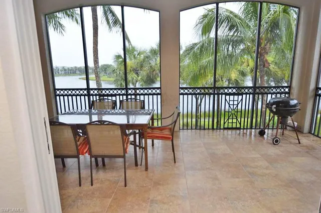 a view of a chairs and table in the balcony