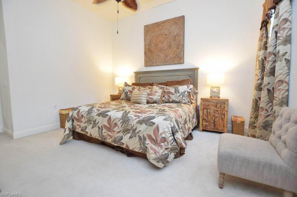 9267 Museo Circle, Unit 204 Naples, FL 34114 - Photo 14 of 24 a bedroom with a bed and a couch