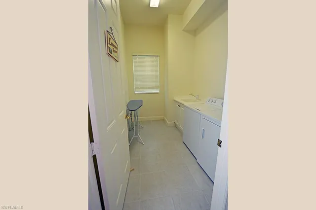 a dining room with furniture and a floor to ceiling window