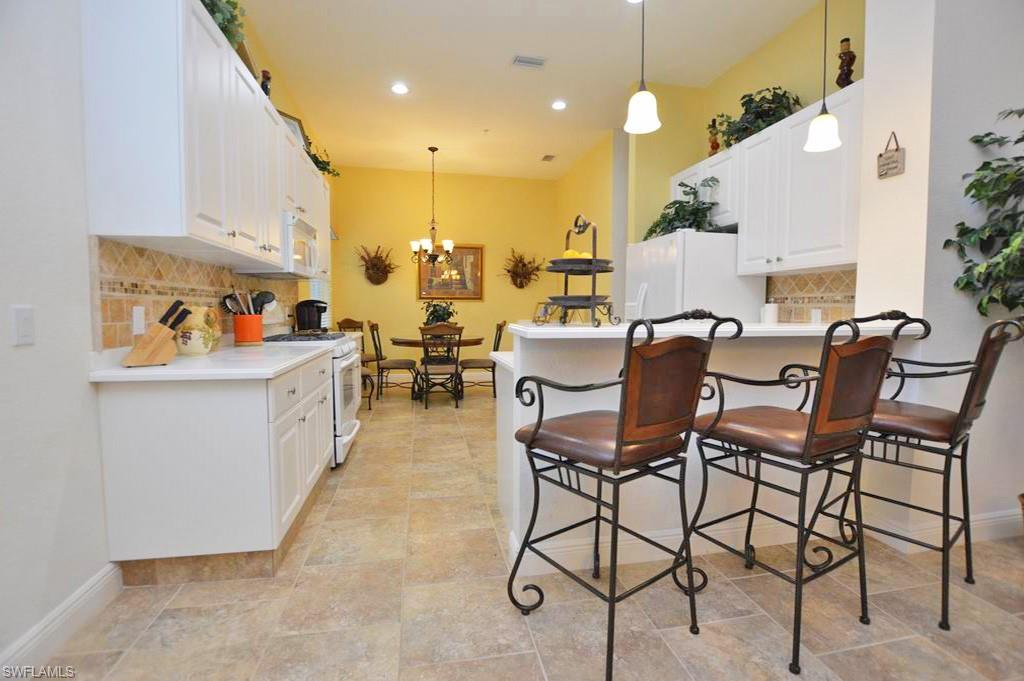 9267 Museo Circle, Unit 204 Naples, FL 34114 - Photo 9 of 24 a view of a dining room with furniture