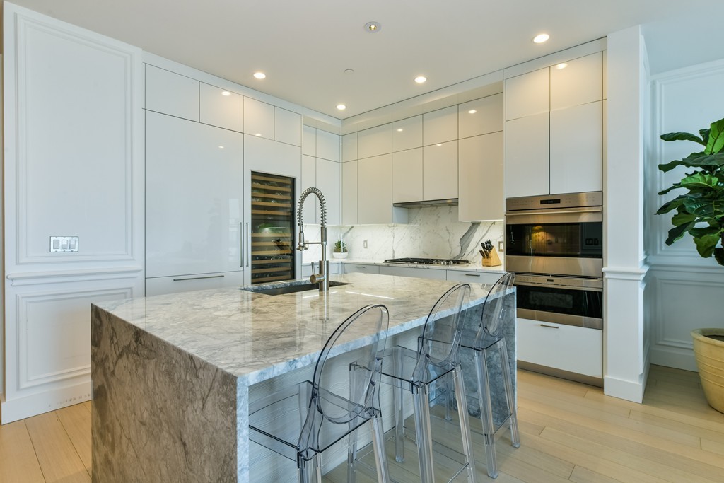 1 Franklin Street, Unit 5201 Boston, MA 02110 - Photo 12 of 23 a kitchen with kitchen island a counter top space appliances and cabinets