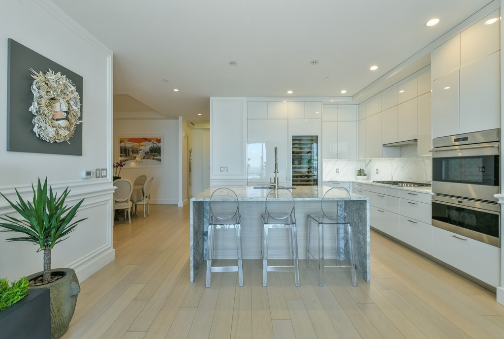 1 Franklin Street, Unit 5201 Boston, MA 02110 - Photo 13 of 23 a kitchen with cabinets table and chairs