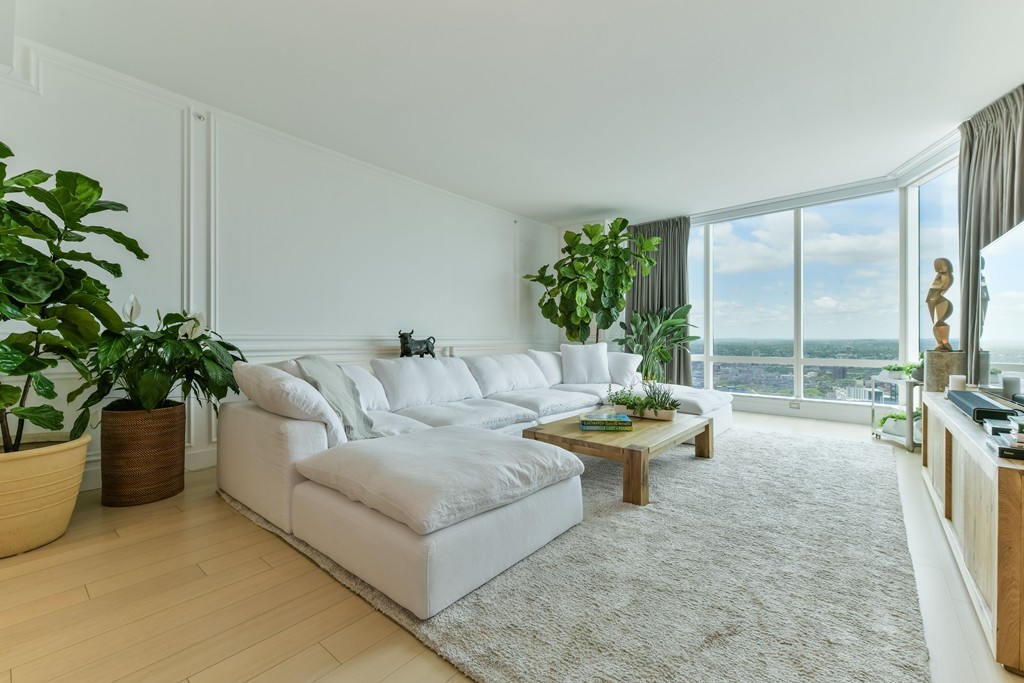 1 Franklin Street, Unit 5201 Boston, MA 02110 - Photo 18 of 23 a living room with furniture and a potted plant