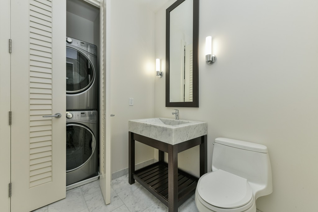 1 Franklin Street, Unit 5201 Boston, MA 02110 - Photo 23 of 23 a bathroom with a toilet a sink and mirror