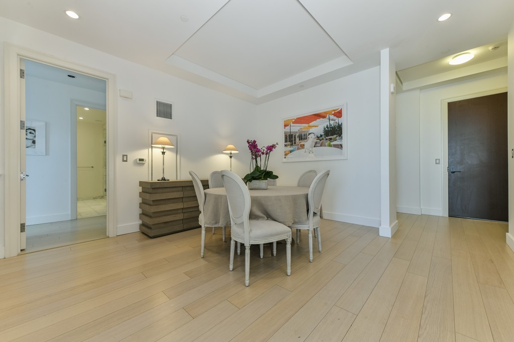 1 Franklin Street, Unit 5201 Boston, MA 02110 - Photo 7 of 23 a dining room with furniture and a chandelier