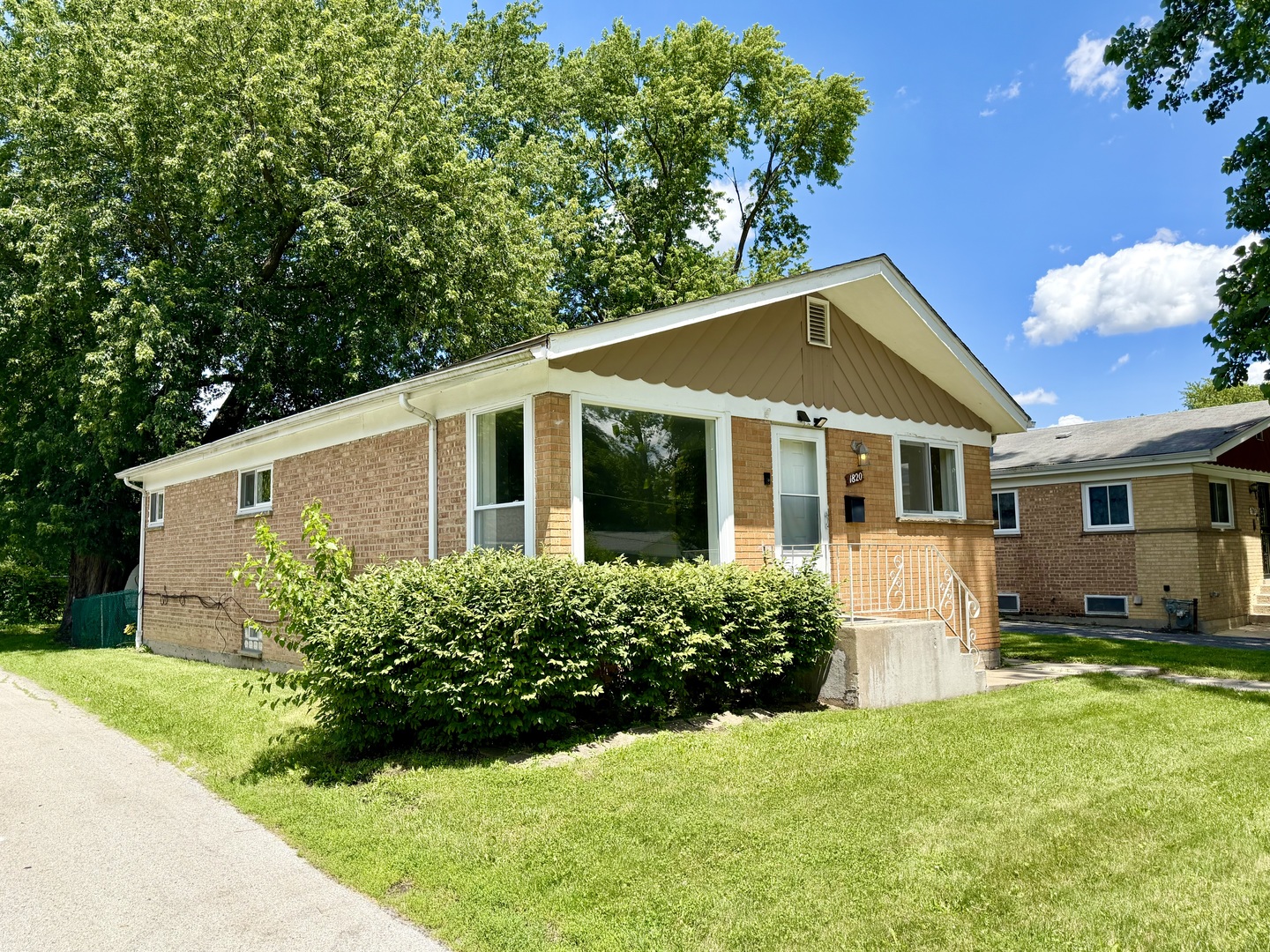 1820 169th Street Hazel Crest, IL 60429 - Photo 3 of 23 a view of a yard in front of a house with plants and large tree