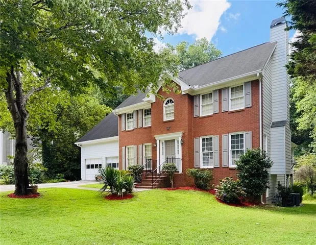 a front view of a house with a yard table and chairs