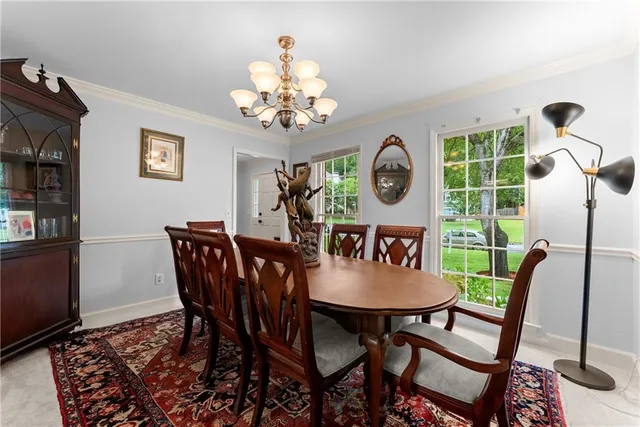 a view of a dining room with furniture wooden floor and a chandelier