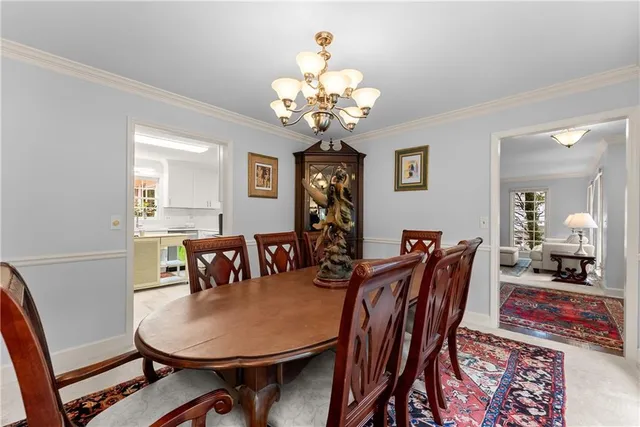 a view of a dining room and hall with furniture