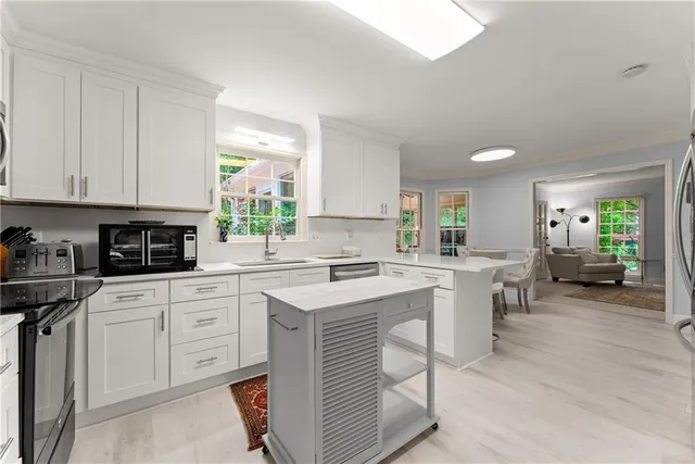 a kitchen with a sink cabinets and appliances