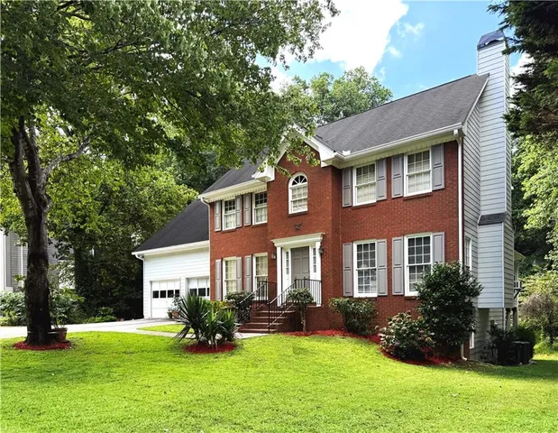 a view of a house with a yard porch and sitting area