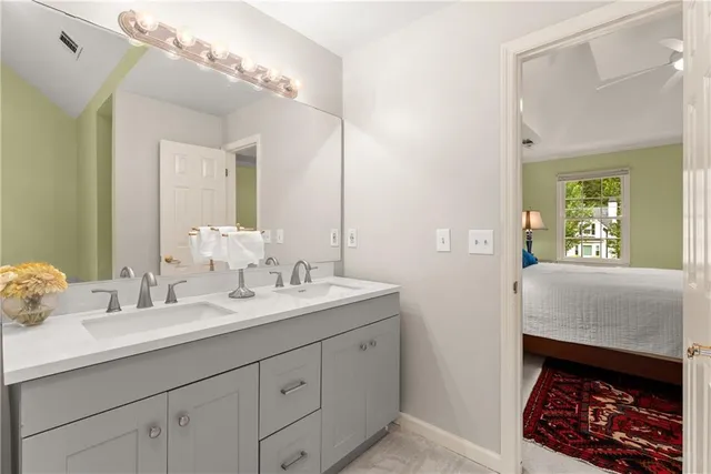 a view of a workspace with furniture and a bookshelf