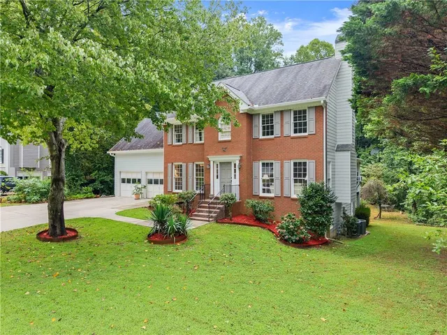 a front view of a house with garden