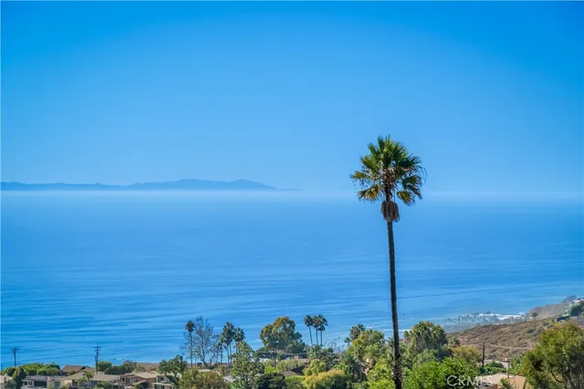 a dining hall with stainless steel appliances kitchen island granite countertop a table and chairs in it