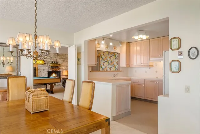 a kitchen with a sink dishwasher and white cabinets with wooden floor