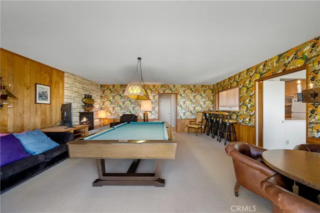 a room with pool table and windows