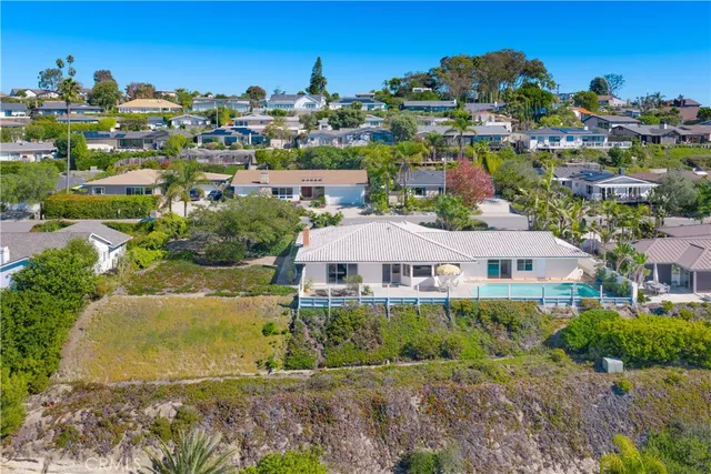 an aerial view of residential houses with outdoor space and street view