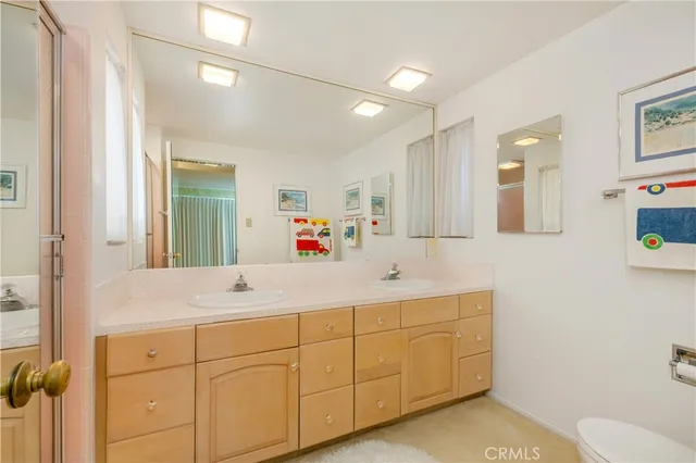 a bedroom with a bed and a lamp on dresser