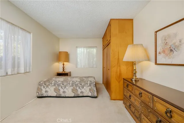 a bedroom with a bed and ceiling fan