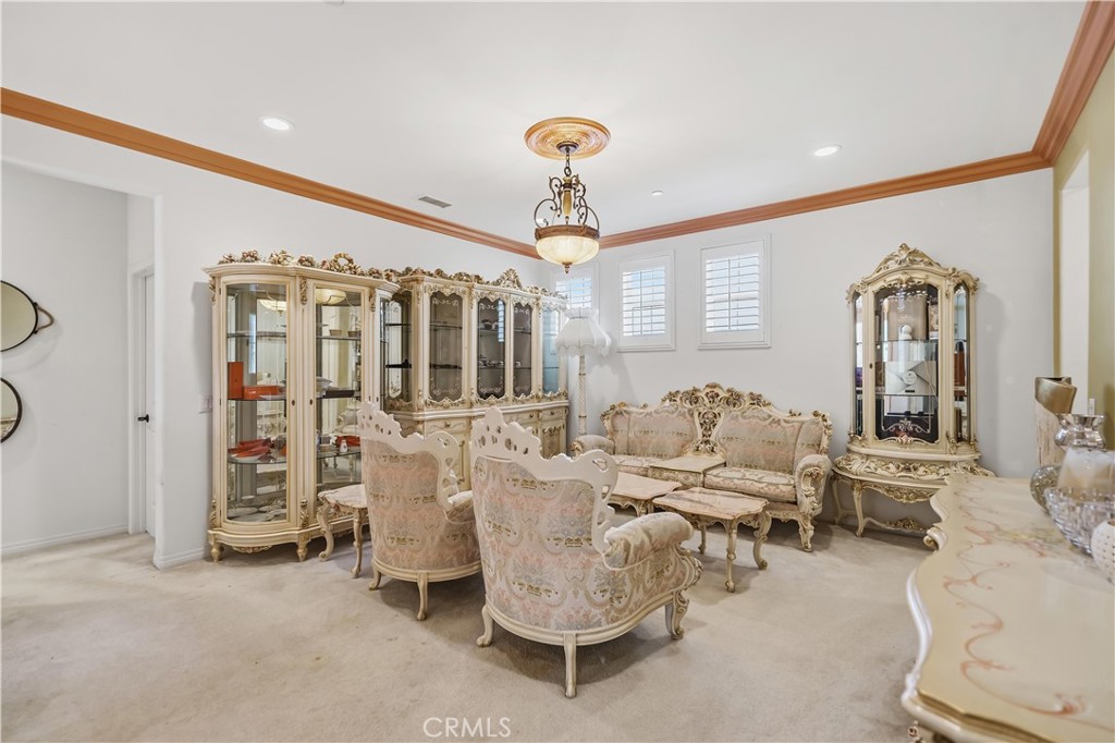 3380 Pine Ridge Loop Ontario, CA 91761 - Photo 17 of 37 a living room with furniture a chandelier and a window