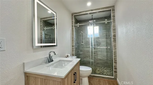 a bathroom with a sink toilet and shower