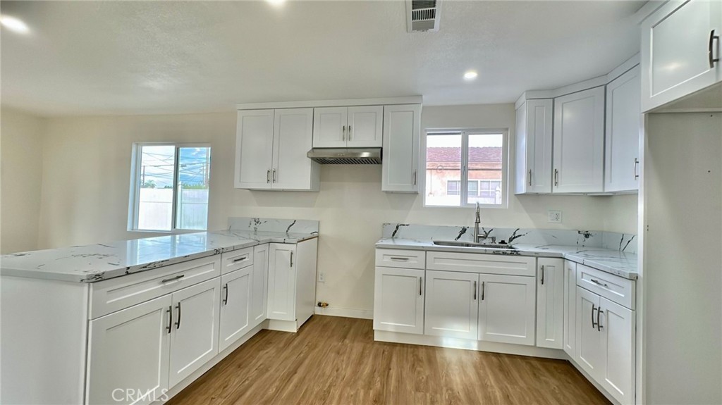 508-508 West Pear Street Compton, CA 90222 - Photo 6 of 14 a kitchen with white cabinets sink and stove