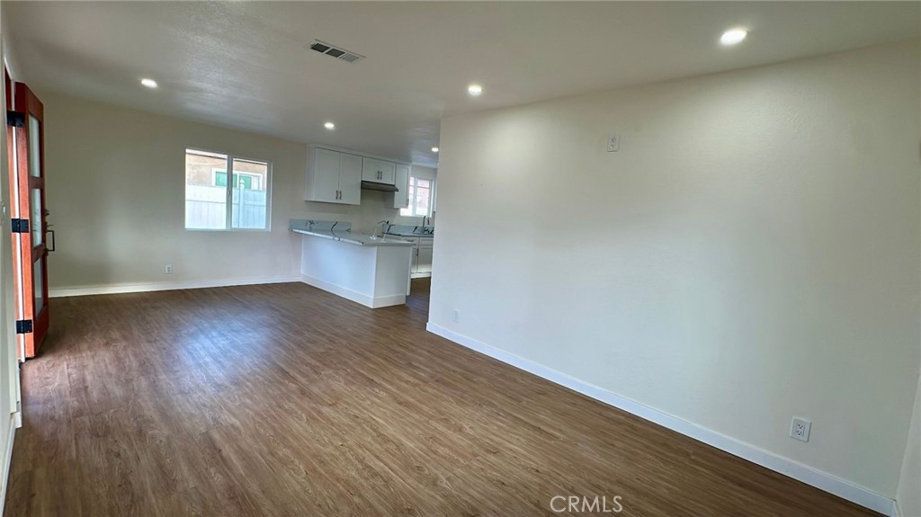 508-508 West Pear Street Compton, CA 90222 - Photo 9 of 14 an empty room with wooden floor and windows