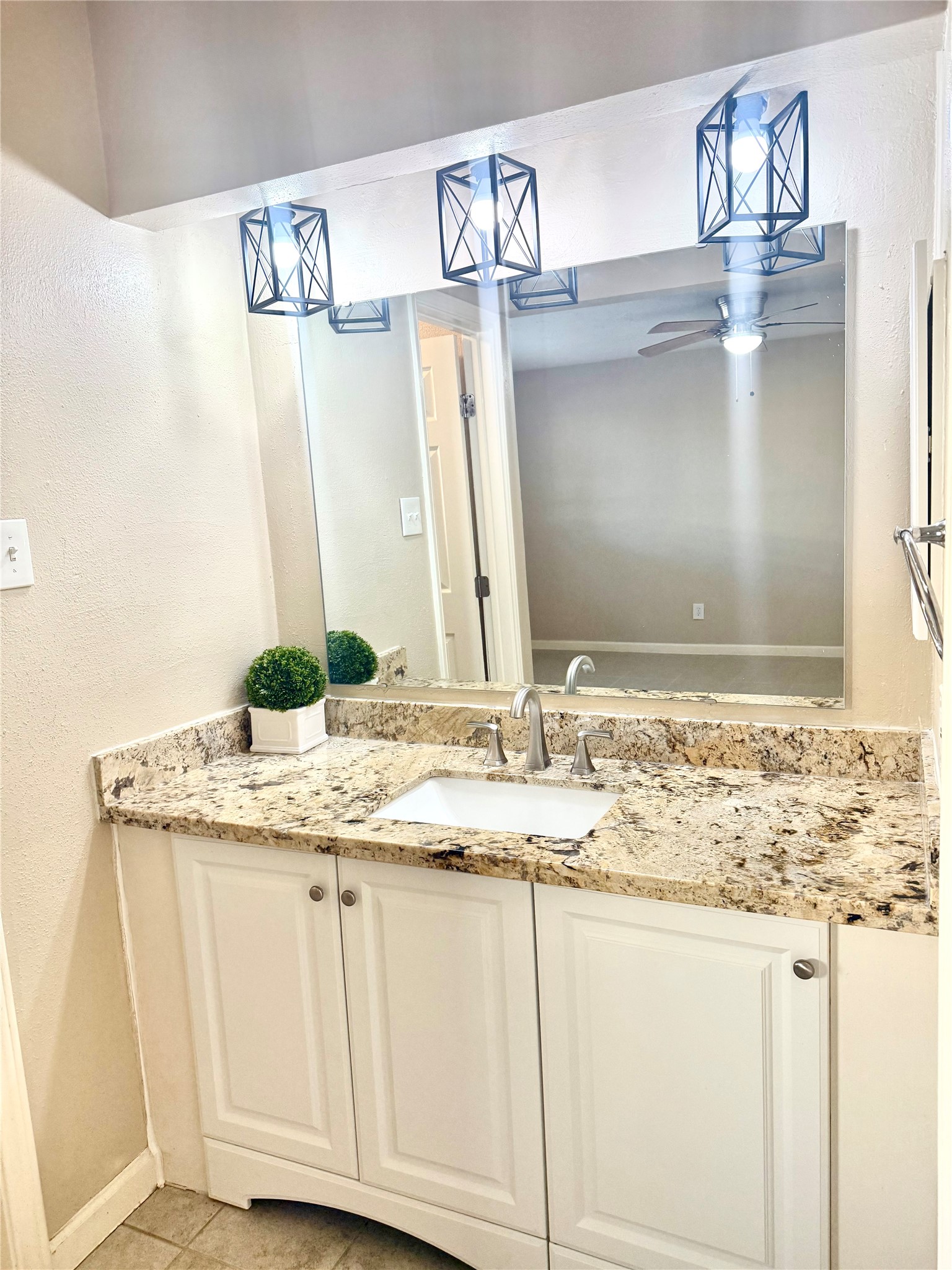 408 Bay Ridge Drive League City, TX 77573 - Photo 11 of 22 a bathroom with a granite countertop sink and a mirror