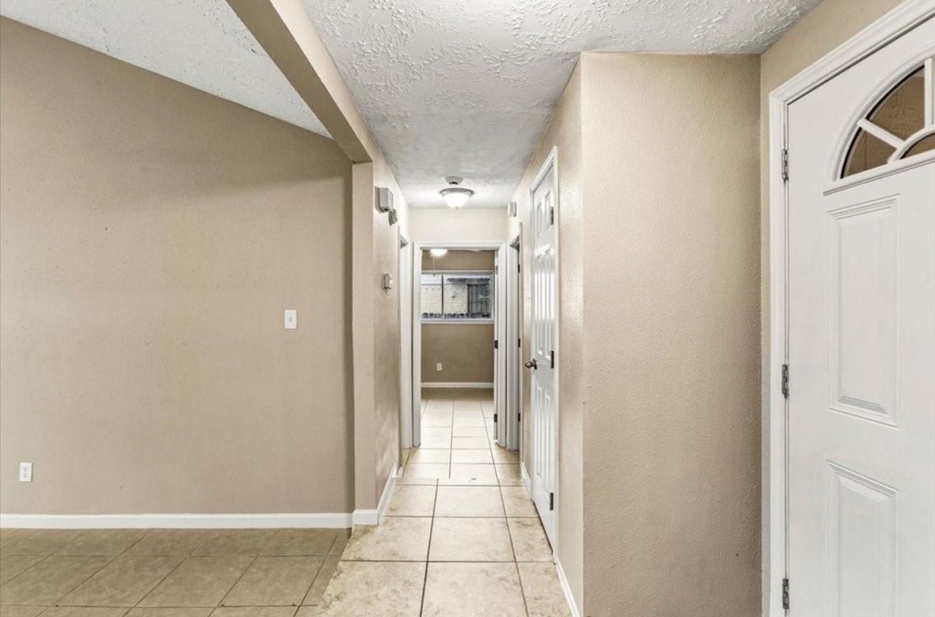 408 Bay Ridge Drive League City, TX 77573 - Photo 8 of 22 a view of a hallway with wooden shelves