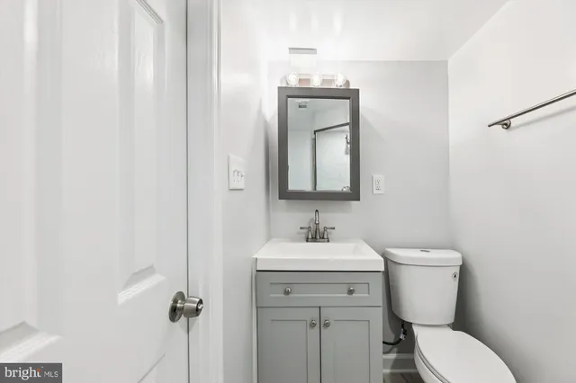 a bathroom with a toilet sink and mirror