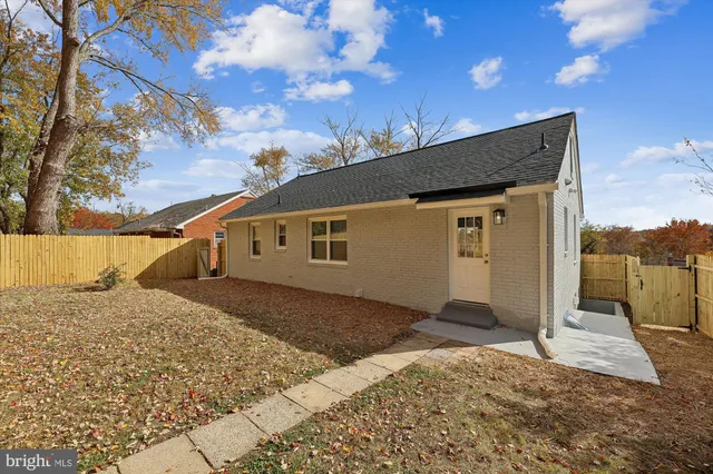 a front view of house with yard and trees