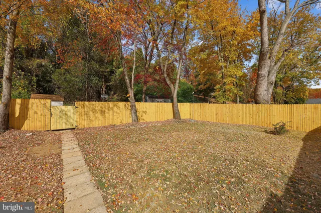 a view of a swimming pool with a patio and a yard