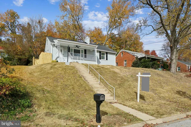 a group of chairs and a table under an umbrella
