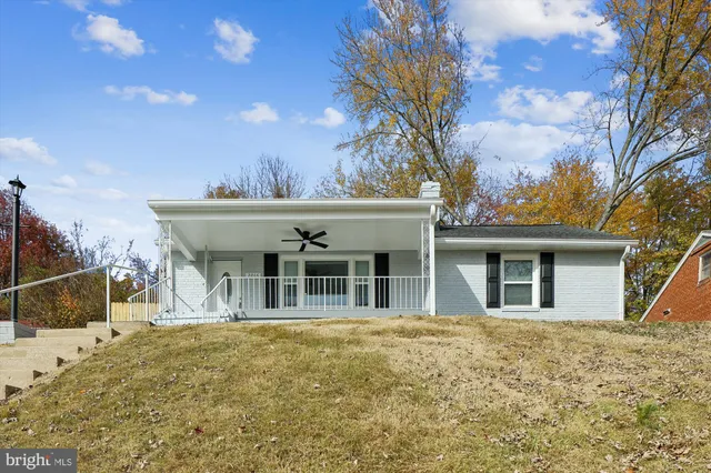 a front view of a house with swimming pool and sitting area