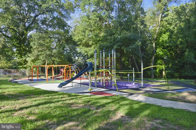 a view of a yard with wooden fence