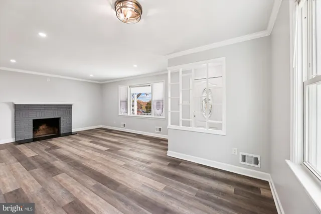 a view of empty room with window and fireplace