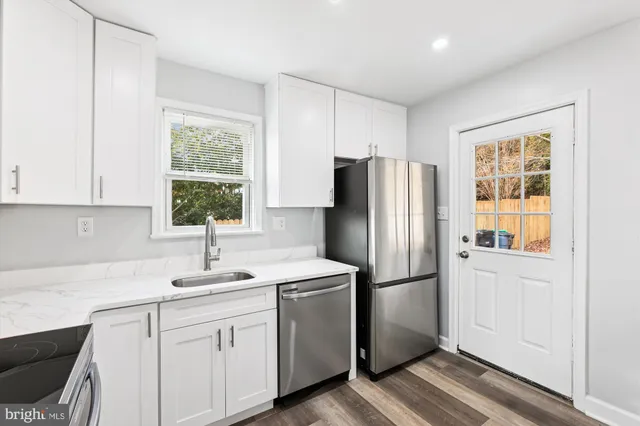 a kitchen with appliances a sink and a window