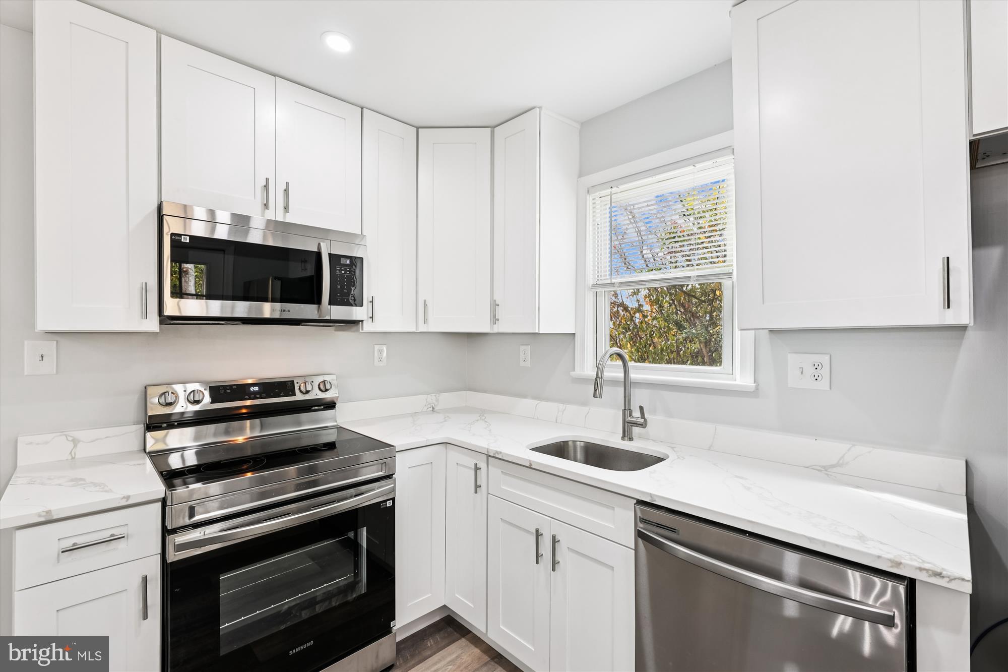 2016 Belfast Drive Fort Washington, MD 20744 - Photo 7 of 61 a kitchen with a sink stove and microwave