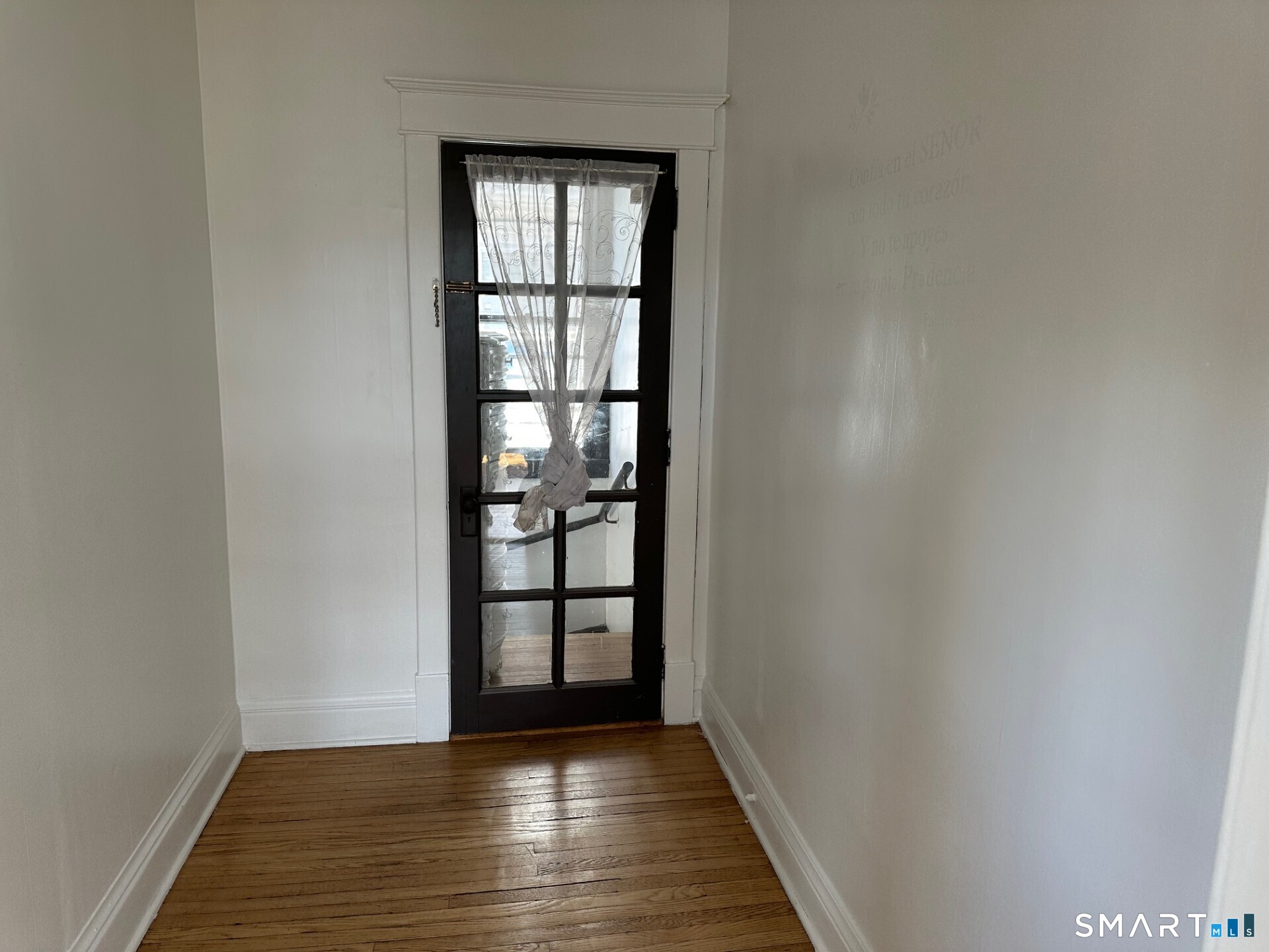 20 Taylor Street Torrington, CT 06790 - Photo 2 of 19 wooden floor in an empty room with a window
