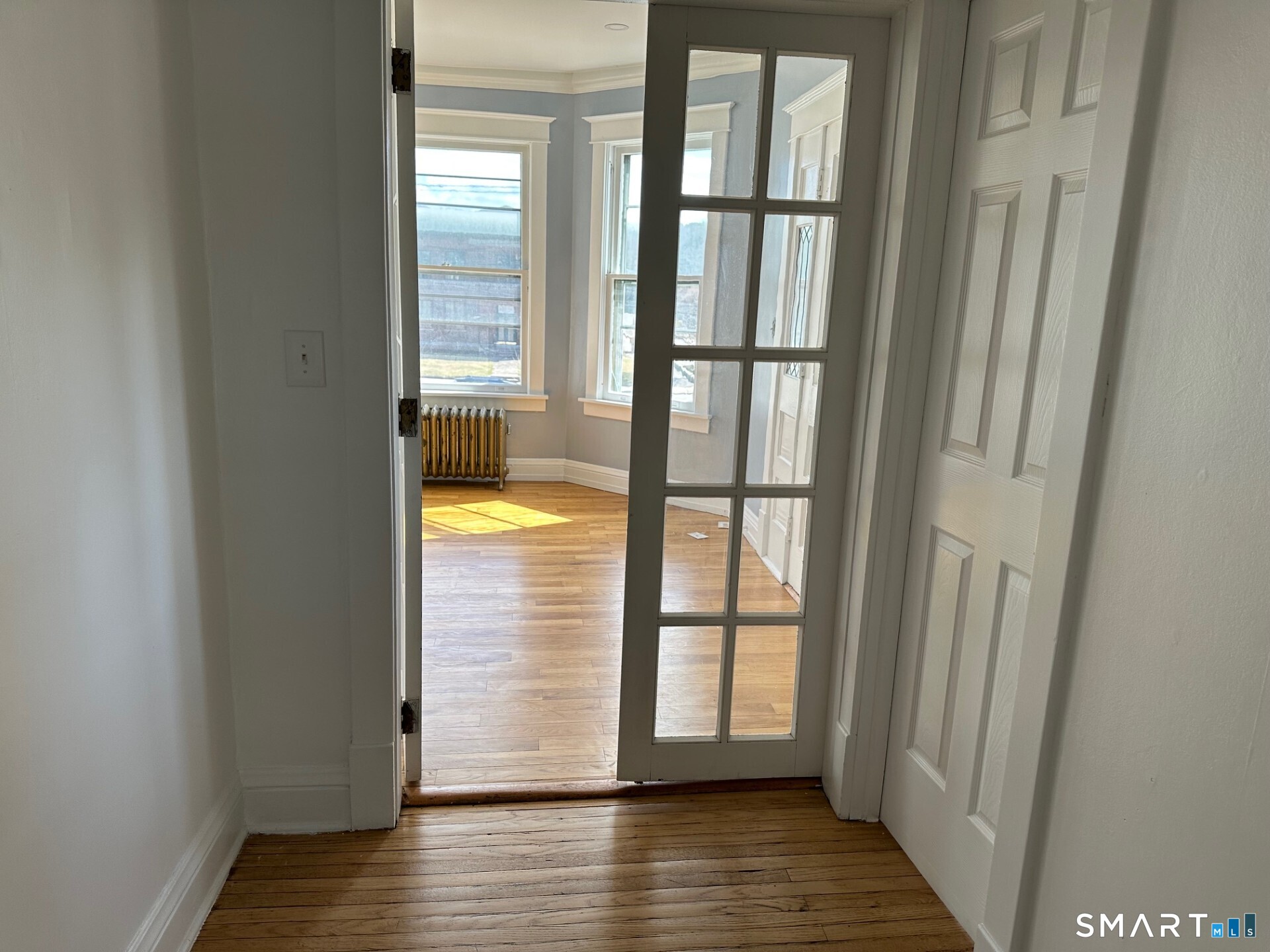 20 Taylor Street Torrington, CT 06790 - Photo 4 of 19 a view of an empty room with wooden floor and a window