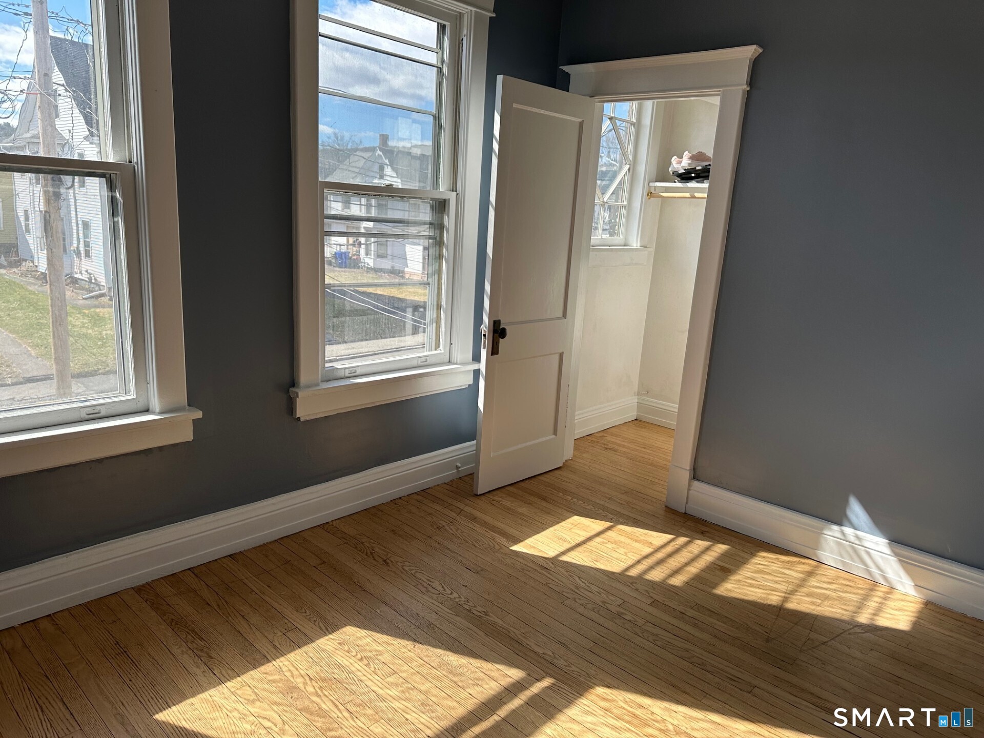 20 Taylor Street Torrington, CT 06790 - Photo 9 of 19 a view of an empty room and wooden floor and windows