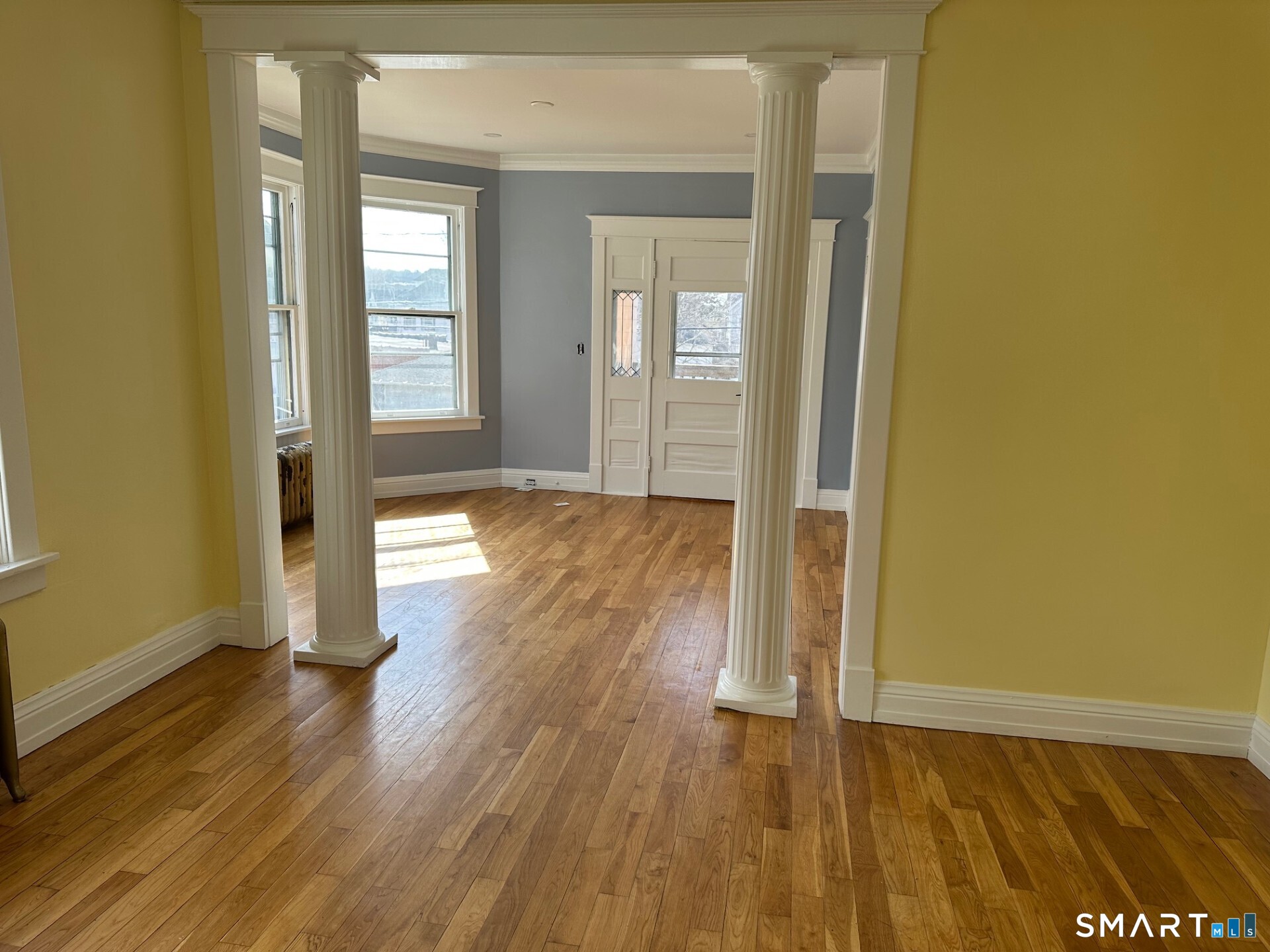 20 Taylor Street Torrington, CT 06790 - Photo 10 of 19 an empty room with wooden floor and windows