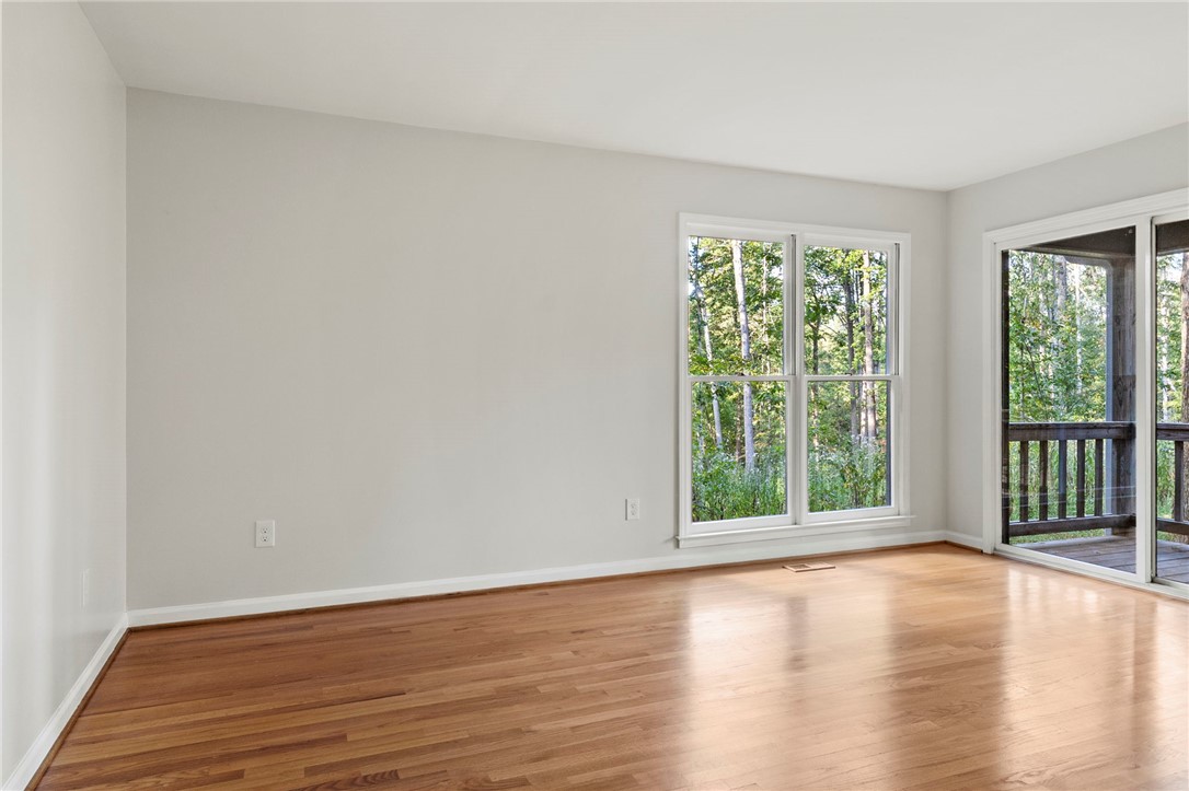 225 Arrowhead Trail Easley, SC 29642 - Photo 29 of 33 Bright interior space features gleaming hardwood floors and large windows, offering tranquil tree views.