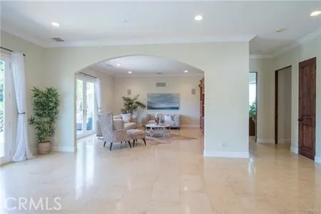 an entryway and livingroom with furniture