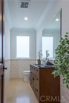 a bathroom with a granite countertop sink a toilet and a mirror