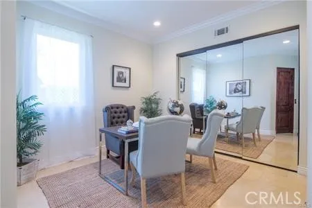 a dining room with furniture and window
