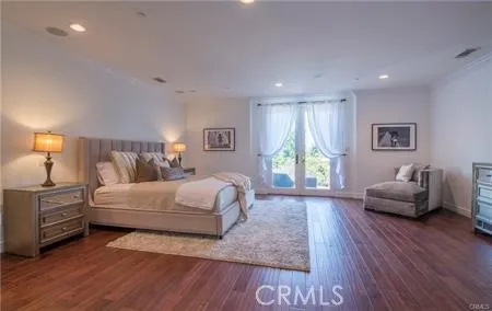 a spacious bedroom with a bed and a couch