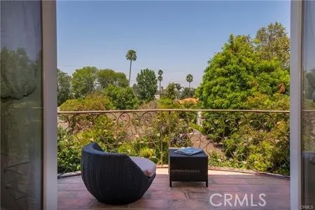 a view of a balcony with chair and potted plants